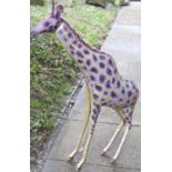 A novel hollow sheet metal constructed ornament in the form of a giraffe with brightly painted