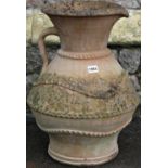 A weathered clay pitcher with drawn neck, moulded loop handle and thumb pressed banded detail, 50 cm