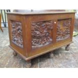 A 19th century oak coffer, the rising lid fitted with two panels showing oak leaves and acorns,
