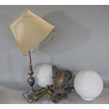 A pair of white opaque globular light shades, a silver plated table lamp and a gimbled candle holder