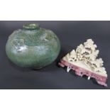 An oriental vase with green mottled glaze and moulded fish and waterweed detail, 11.5cm tall approx,
