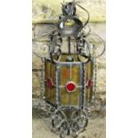 A hanging porch/hall lantern of hexagonal form with textured coloured glass panels within a