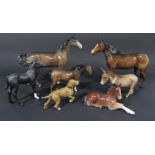 A collection of Beswick horses comprising three standing bay examples, together with a matt black