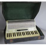 A pearlized cased Italian piano accordion in working order, with original case and strap by