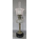 A Young's oil lamp, classical brass column stand with a clear font, floral flared shade, 68 cm high