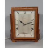 A Ferranti mantel clock in an art deco style, the oak case enclosing an electric movement, with