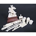 A collection of Victorian and later carved ivory sewing effects including clamps, needle cases,