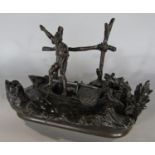 A 19th century bronze inkwell and pen holder of a fishermen standing in a rowing boat in a riverside