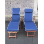 A pair of contemporary weathered hardwood folding steamer type armchairs with slatted seats, backs