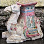 A pottery garden/conservatory seat modelled as a camel with polychrome decoration (af)