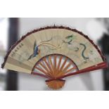A decorative Japanese fan, 92 cm radius with bird and dragon detail, a shoe horn, two silver