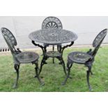 A cast aluminium garden terrace table of circular form with decorative pierced top raised on