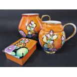 A collection of Carltonware art deco lustre wares in the Hollyhock pattern on an orange ground