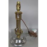 A ships brass gimble table lamp on a revolving steel base, 30 cm high