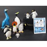 A collection of ceramic penguins including a boxed pair of Wade limited edition examples modelled by