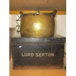 An antique oval brass cauldron with removable lid and loose steel handle, together with a japanned