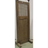 An antique oak freestanding screen with lattice panel, peg frame and raised on sledge supports, 56