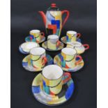 A collection of Grays Pottery art deco coffee wares with brightly coloured geometric painted