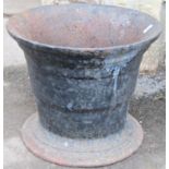 A heavy antique cast iron mortar of circular tapered form with flared rim and base, 35 cm in
