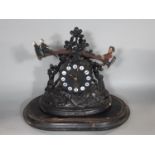 An American mantel clock in carved spelter, the clock face simulating a timber log, with applied