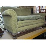 An Edwardian two seat sofa with swept and rolled arms and green coloured cut floral Mouquet