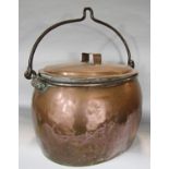 A large 19th century, oval copper cauldron with lid and a wrought iron handle, 48cm x 31cm.