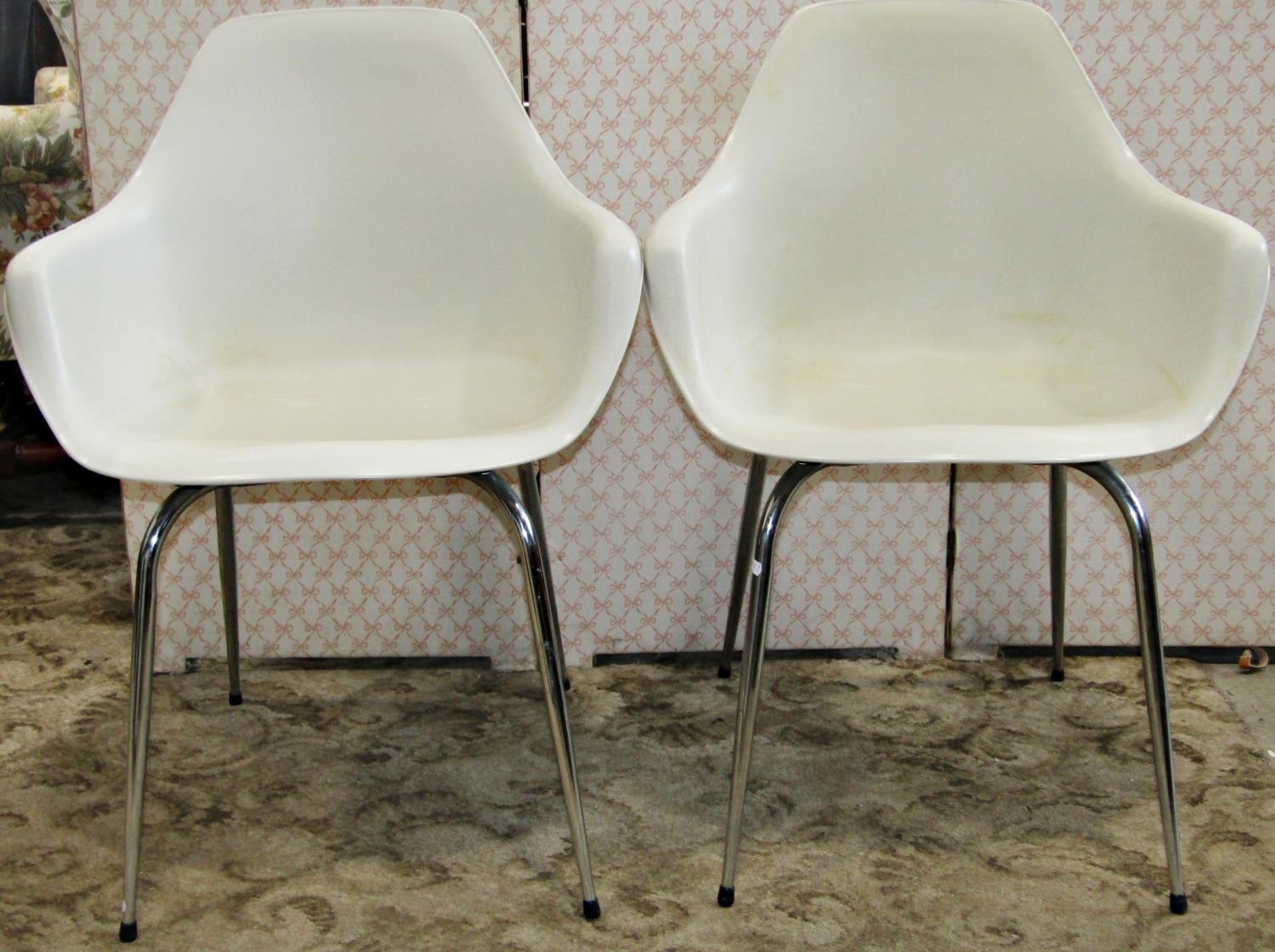 A set of four moulded plastic retro dining chairs with shaped outline raised on tubular supports, - Image 2 of 2