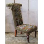 A Victorian pre dieu, with floral tapestry and beadwork seat and T shaped back, raised on stained