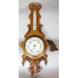 An oak 19th century aneroid barometer with thermometer above, made by J Blowey Plymouth. 86cm.