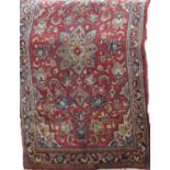 A Sarouk Mahal rug with an overall floral panel upon a red ground, 205cm x 130cm