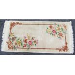 A Chinese thick pile rug with bamboo framed floral motif on a fawn ground, 160 x 80cm