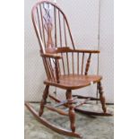 A reproduction Windsor style stained beechwood hoop and stickback rocking chair with central pierced