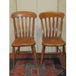 A harlequin set of eight Windsor elm and beechwood lathe back kitchen chairs raised on turned
