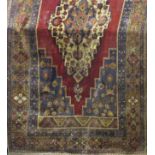 A middle eastern design carpet with stepped central medallion and all over floral pattern, 310cm x
