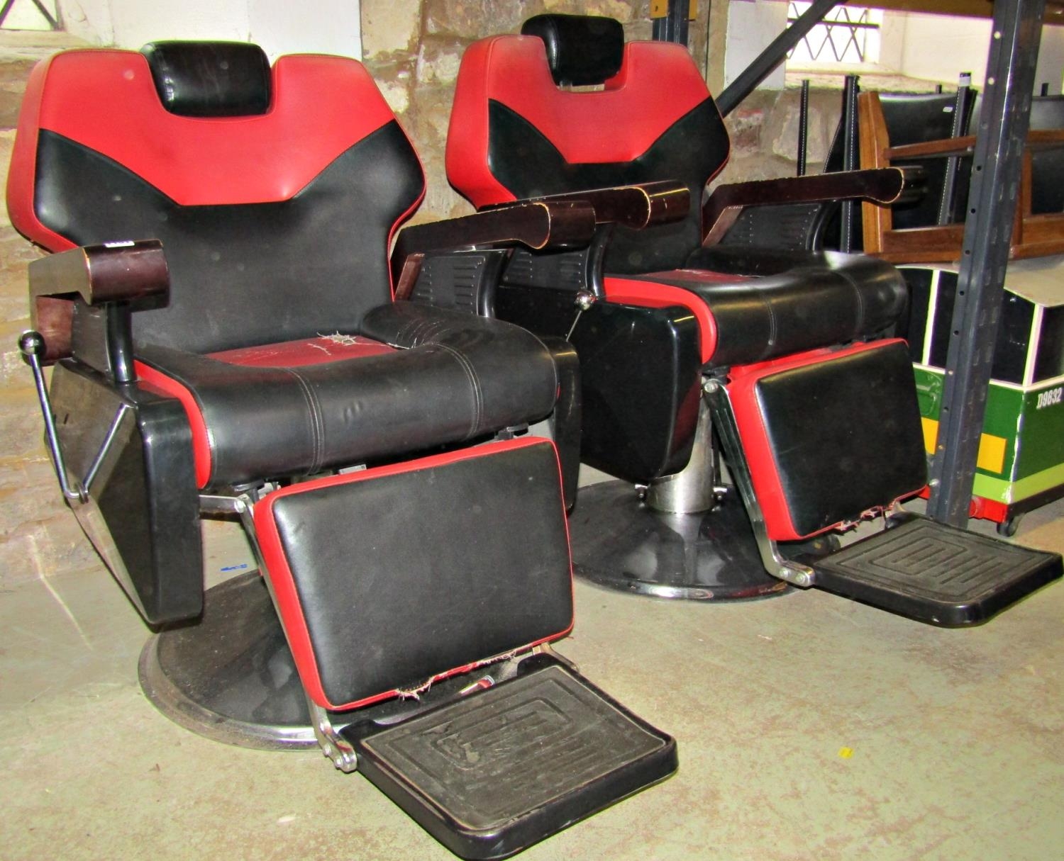 A pair of retro style height adjustable and revolving barbers' chairs, stitched two tone faux