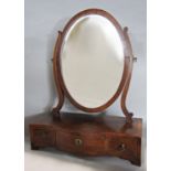 A Georgian mahogany toilet mirror, with an oval mirror on a three drawer stand