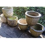 Six small weathered cast composition stone circular planters (two designs) with repeating relief