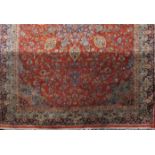 A Persian Bidjar design carpet with all over floral design upon a red ground, 270cm x 190cm