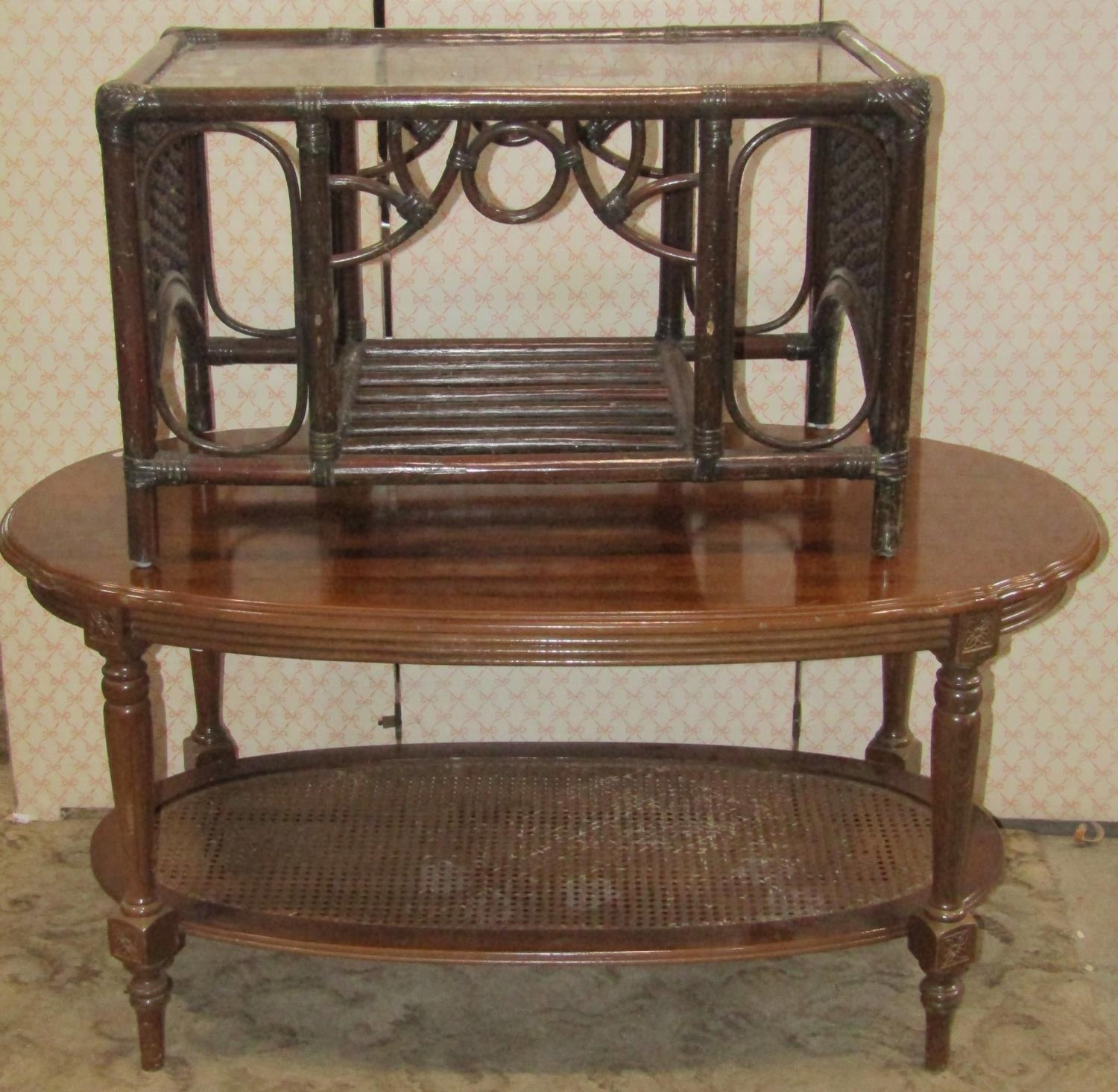 A reproduction two tier occasional table of oval form with moulded outline together with a further