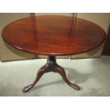 A Georgian mahogany snaptop occasional table, the circular top 86 cm diameter raised on a gun barrel