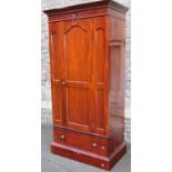 A Victorian style mahogany single wardrobe with stepped and moulded cornice over a panelled from,