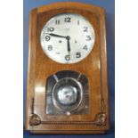 An art deco oak wall clock with anodised dial, the case with glazed panel, revealing a chromium