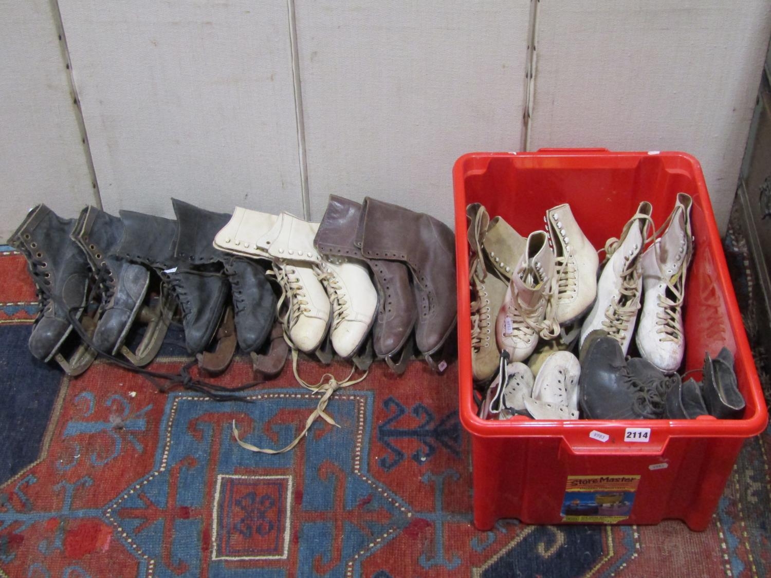 Nine pairs of vintage ice skates, varying size and design