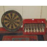 A vintage painted metal shooting gallery with human figure targets, 46 cm wide x 37 cm high,