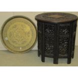 A carved Indian hardwood table with folding frame and an engraved Indian tray