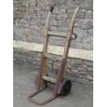 A vintage heavy duty sack truck with iron fittings, ashwood shafts and hard rubber tyres