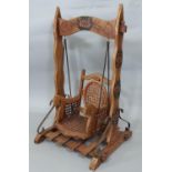 Victorian style dolls swing seat in with cane chair mounted on a painted wood and metal frame (1)