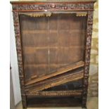 A Victorian carved walnut bookcase with scrolling and trailing fruit detail and open adjustable