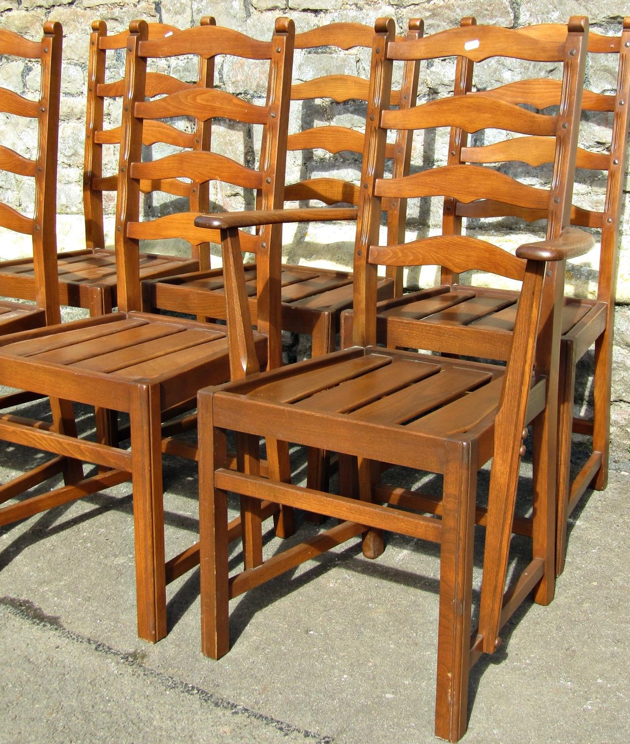 A set of six (5&1) Ercol stained elm wavy ladderback dining chairs with slatted seats, raised on - Image 2 of 3