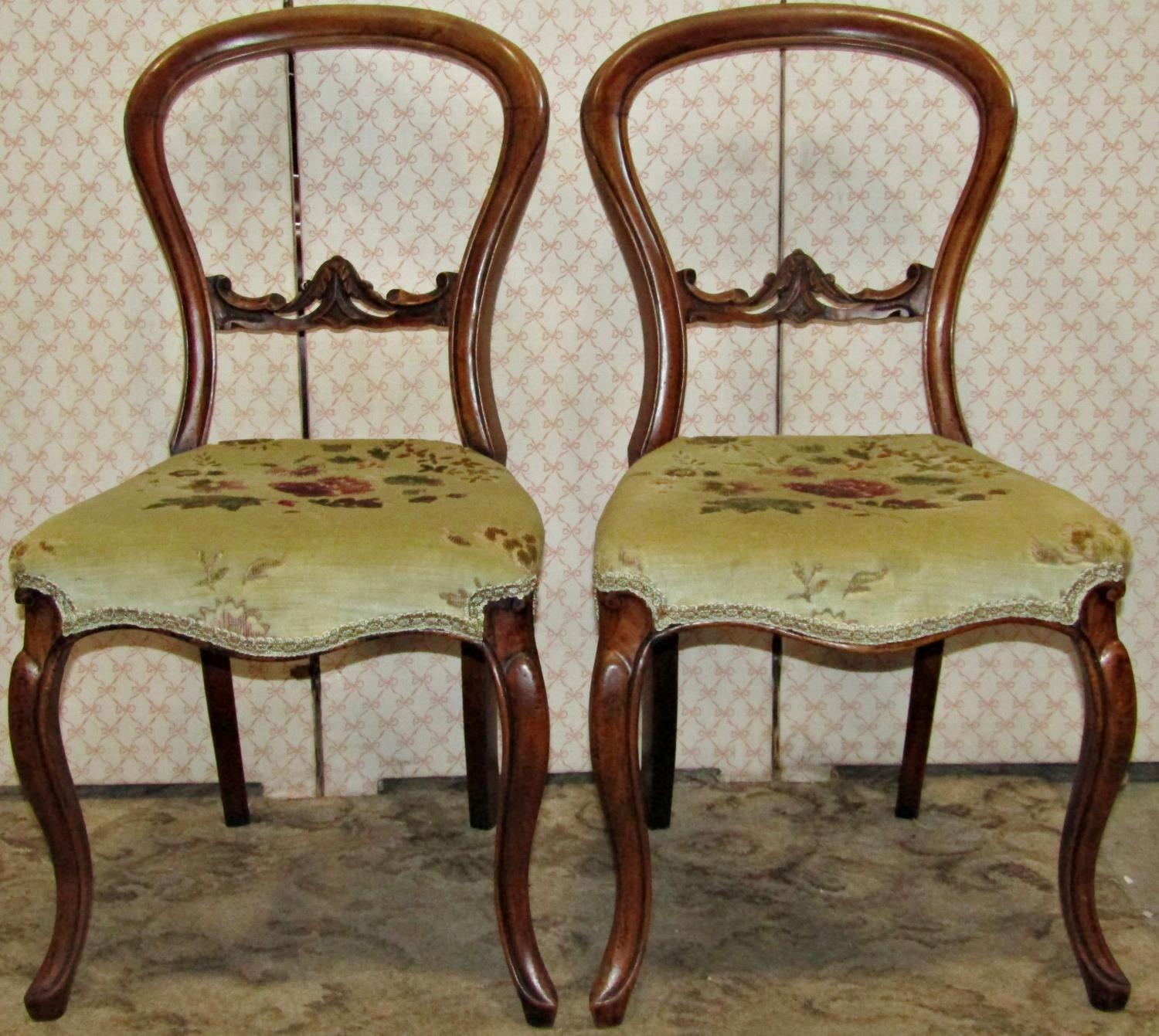 Six Victorian walnut balloonback dining chairs (slight variant in design), with moulded frames